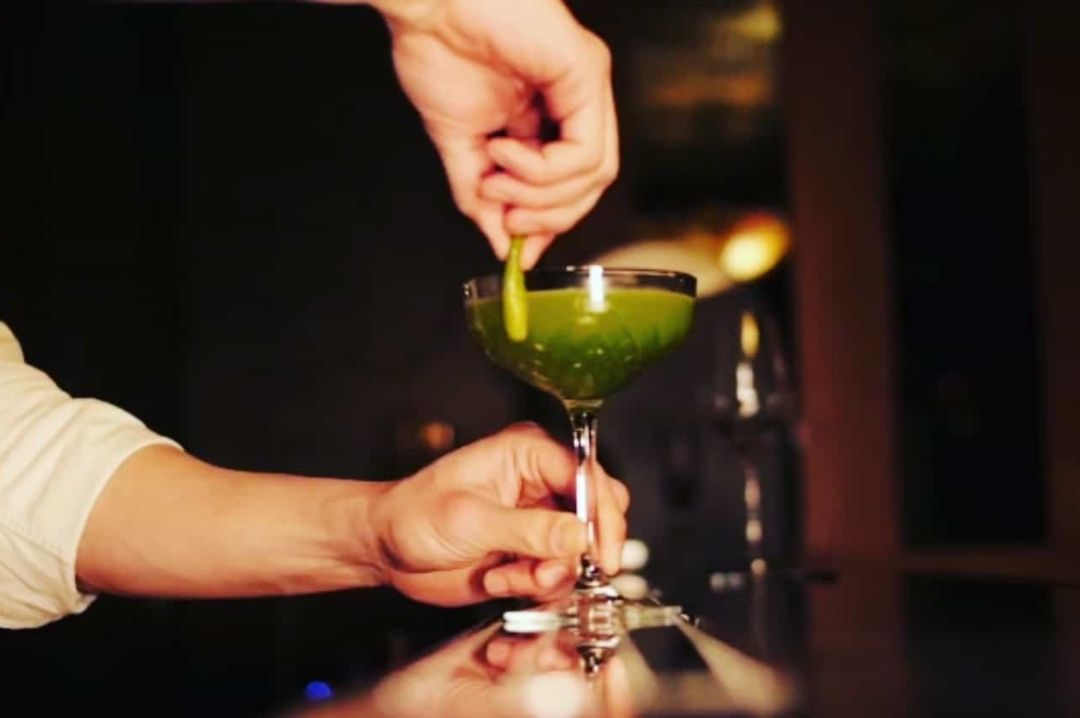 Green colored cocktail dizzygillespiecocktail_hiddenbar_mobsterbar_paris